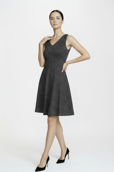 Woman wearing a black sleeveless dress on a white background